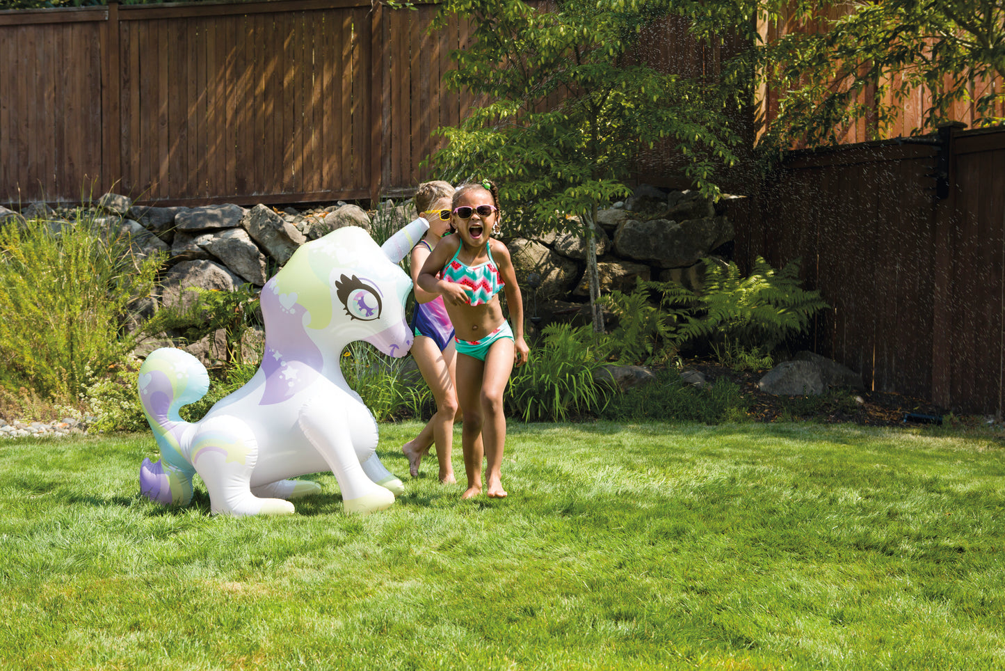 Children playing with inflatable unicorn Mist-Ical Uni Sprinkler