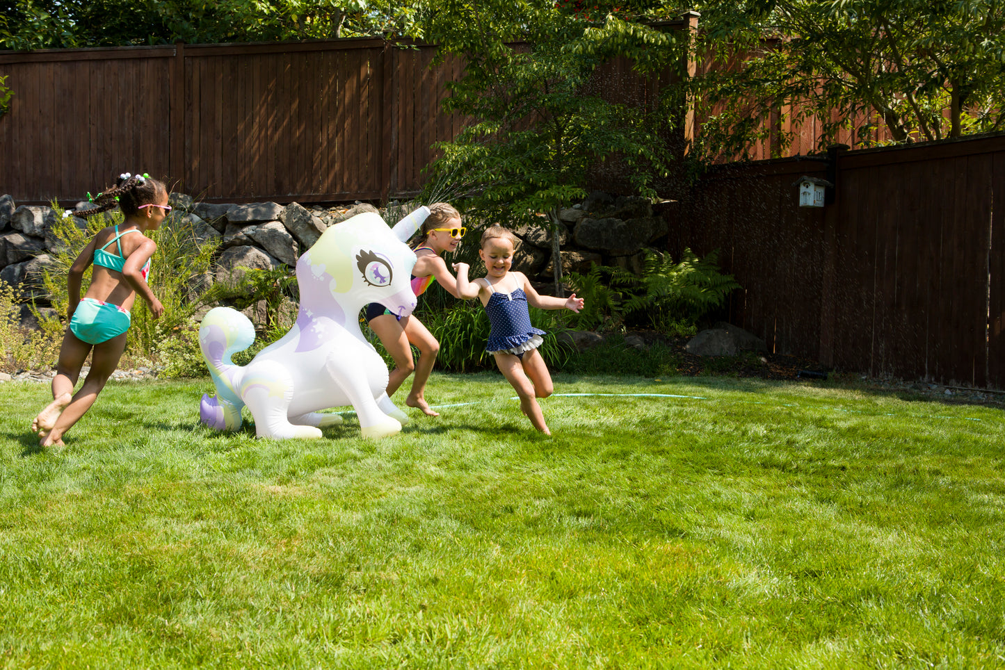 Children playing with inflatable unicorn Mist-Ical Uni Sprinkler