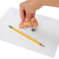 A hand pressing silly putty into a drawing on a sheet of paper. The drawing is being transferred onto the silly putty