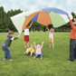 Children outside playing with 10-foot parachute.