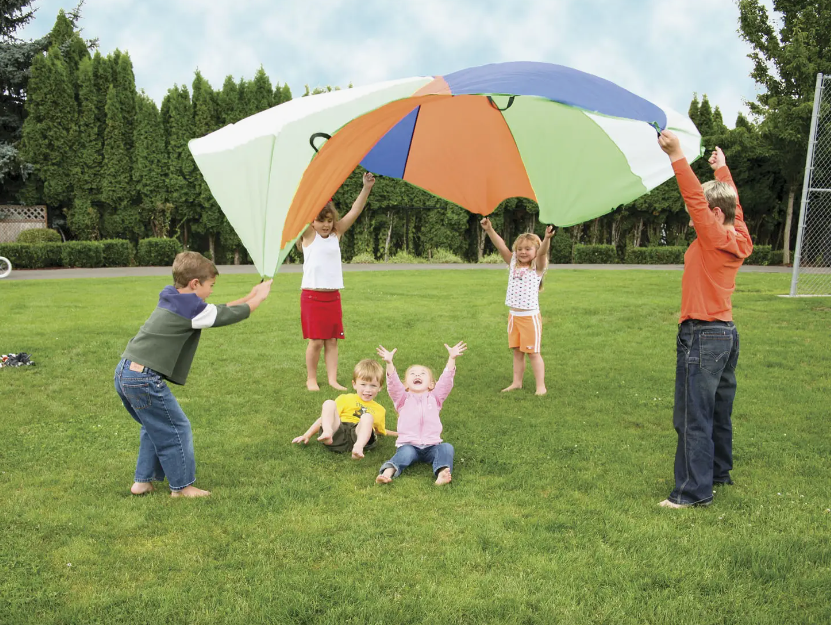 Children outside playing with 10-foot parachute.
